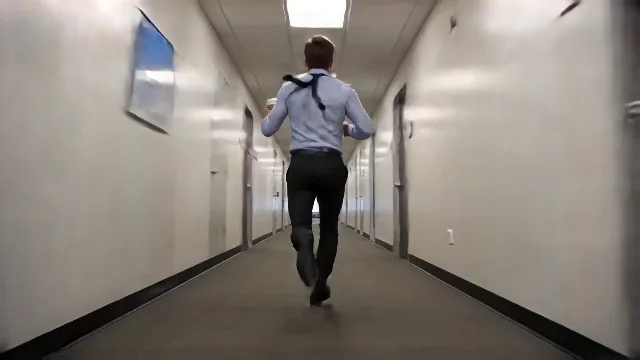 100-meter sprint energy: guy sprints full speed down a long office corridor, ca…